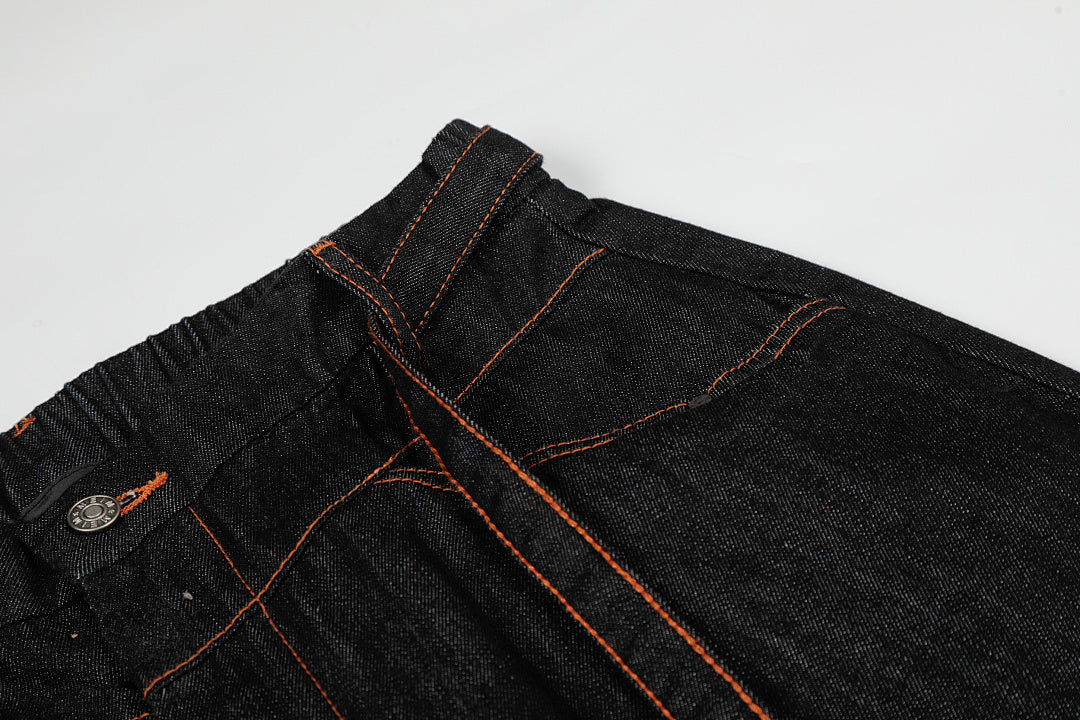 Waist and front pocket details on pleated barrel jeans