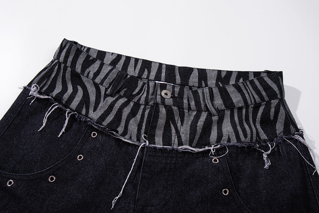 Close-up of the zebra double-waist detail on baggy jeans