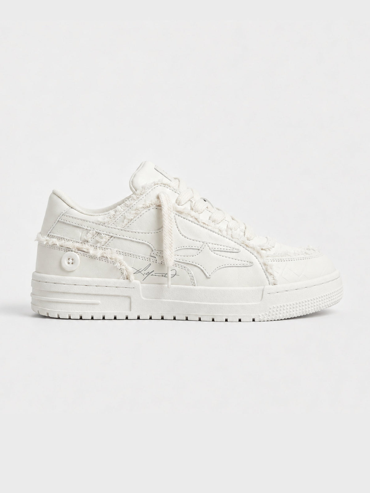 Cream lace-up sneakers shown from the side