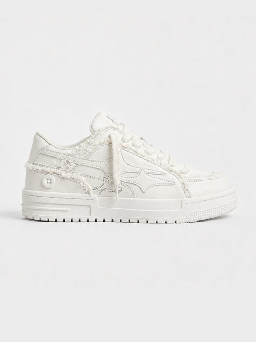 Cream lace-up sneakers shown from the side