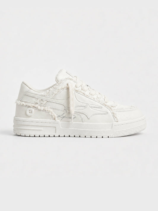 Cream lace-up sneakers shown from the side
