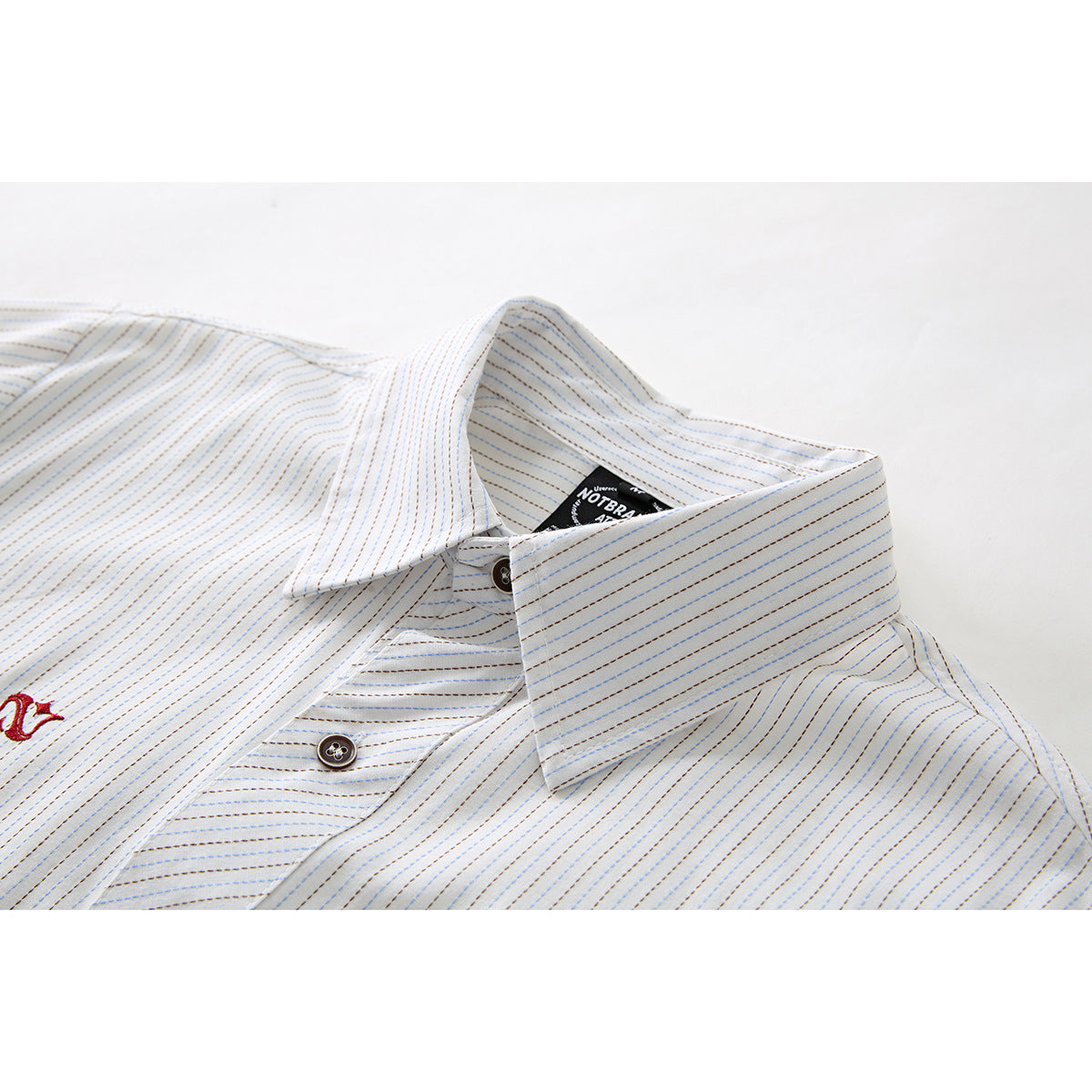 Close-up of the long sleeves and cuff detail on the striped shirt