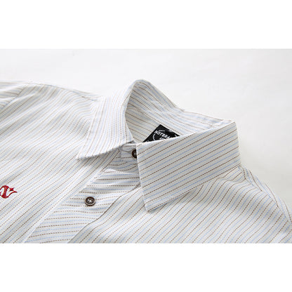 Close-up of the long sleeves and cuff detail on the striped shirt