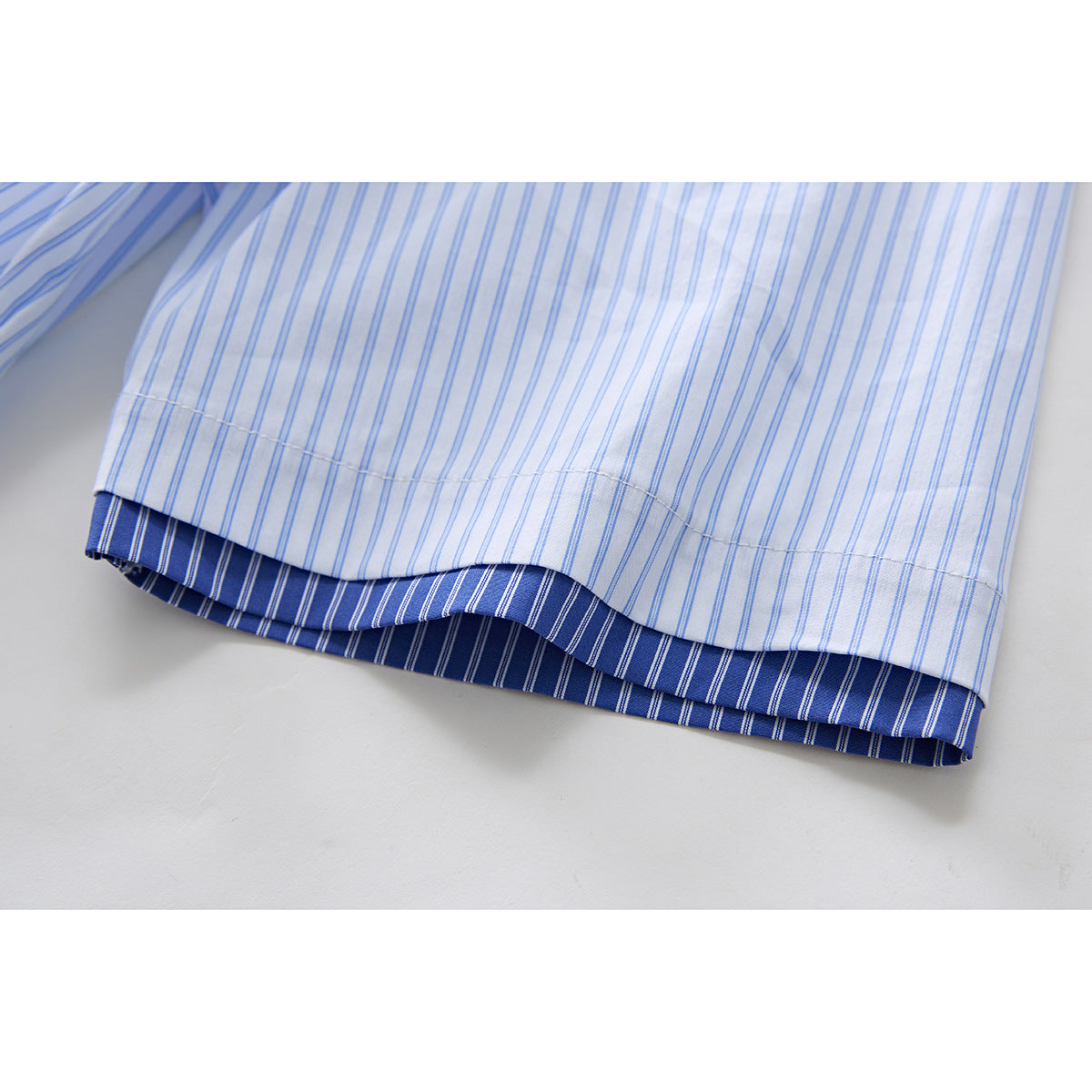Full-length view of model wearing striped button-up shirt