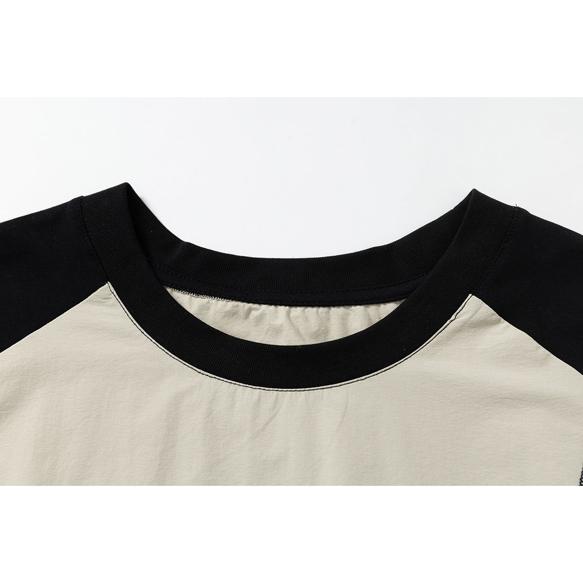 Full view of graphic sleeveless raglan top showcasing relaxed silhouette
