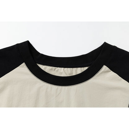 Full view of graphic sleeveless raglan top showcasing relaxed silhouette