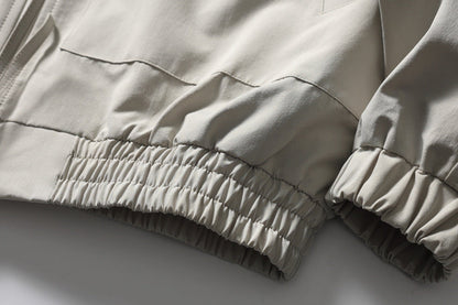 Full-length view of the black and white colourblock track jacket