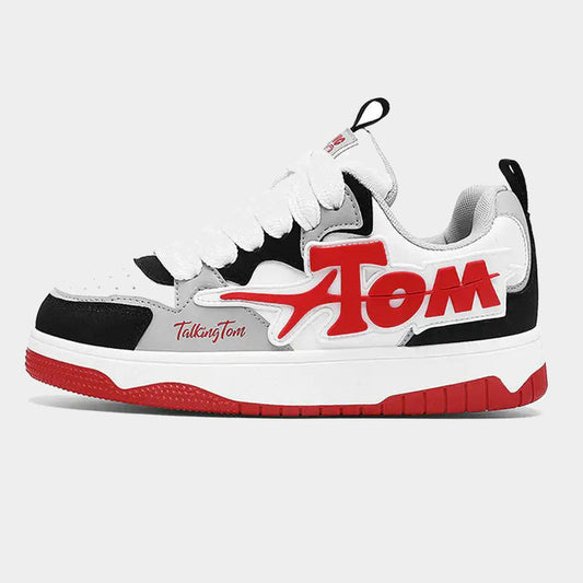 Pair of oversized letter graphic low-top sneakers shown from the side