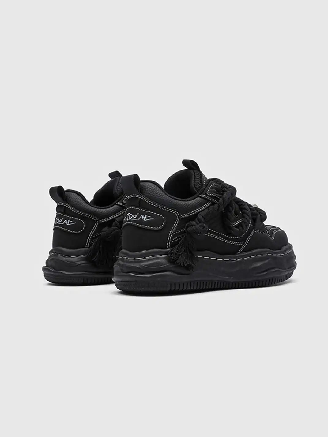 Pair of chunky wavy sole sneakers displayed together