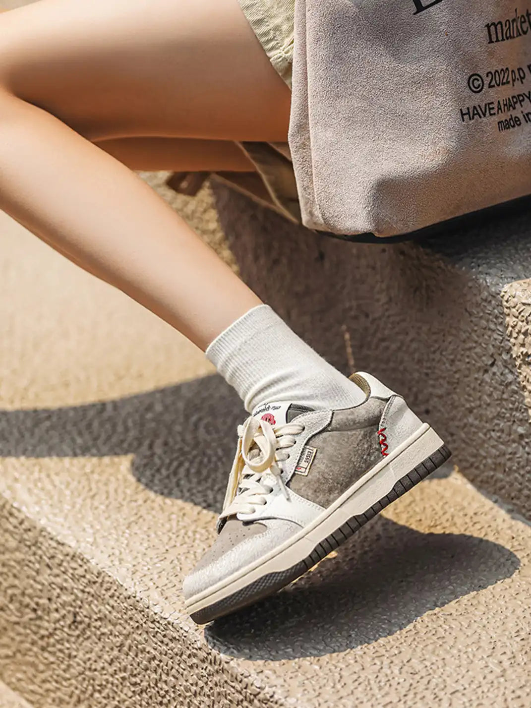 Pair of worn suede low top trainers with panel detailing