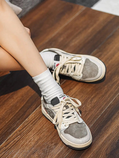 Worn suede trainers showing the lace-up front