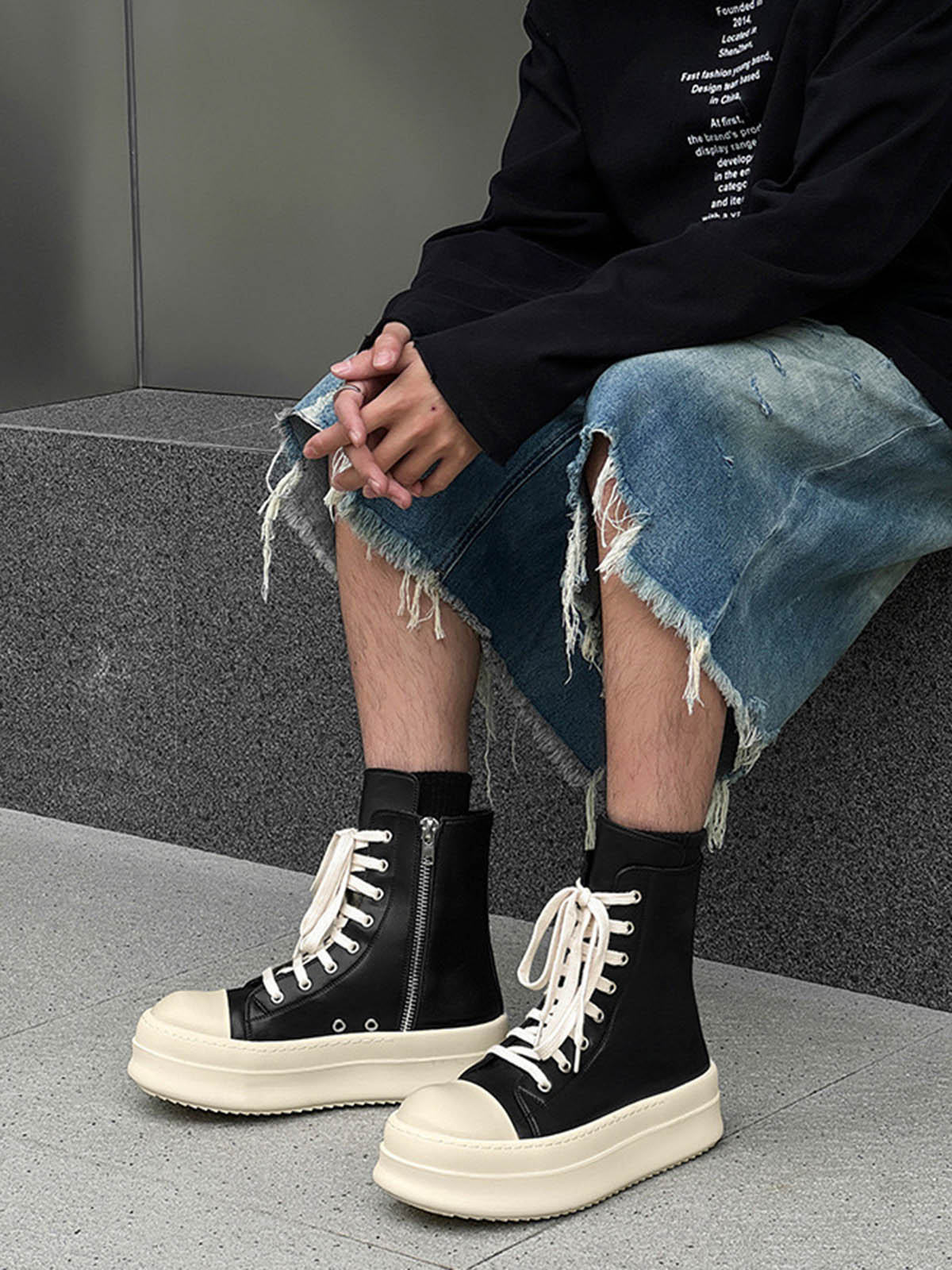 High top platform sneakers displayed at an angle to show their raised sole