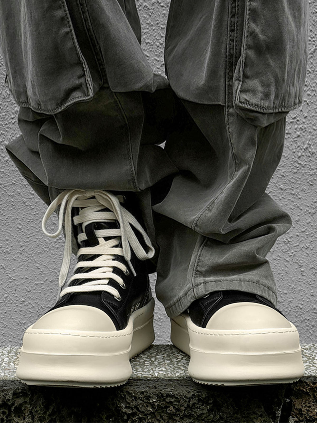 Side view of platform high top sneakers highlighting the ankle-high design