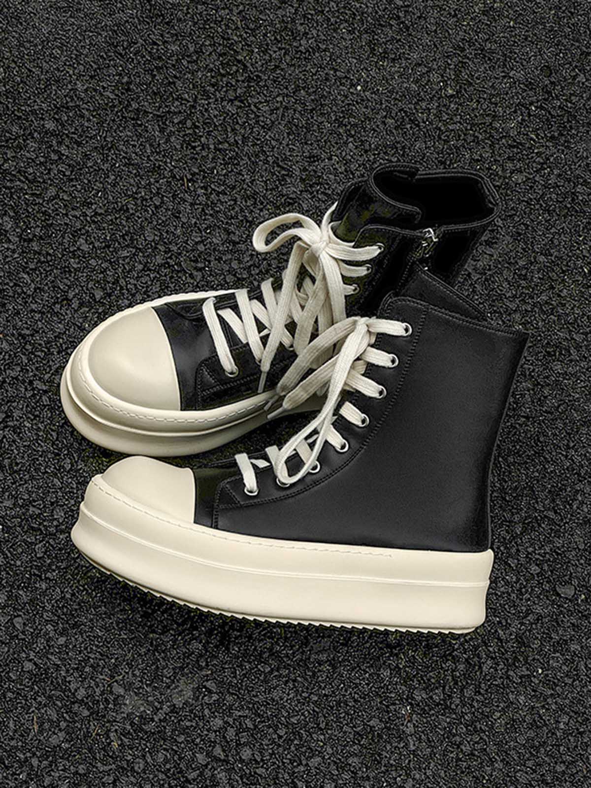 Detailed view of the platform sole and side zip on high top sneakers
