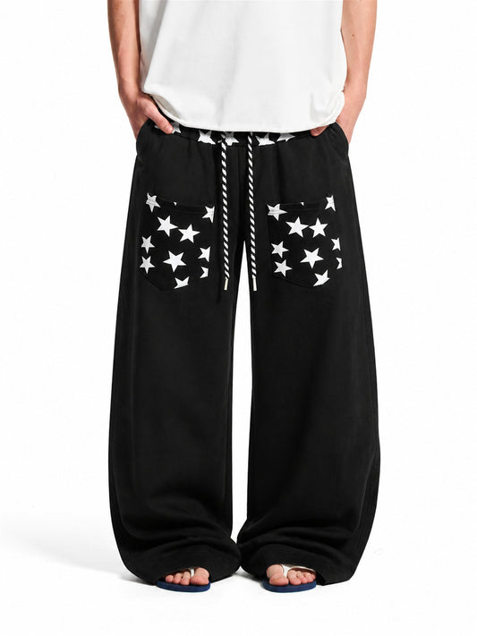 Star print baggy sweatpants styled as relaxed streetwear trousers