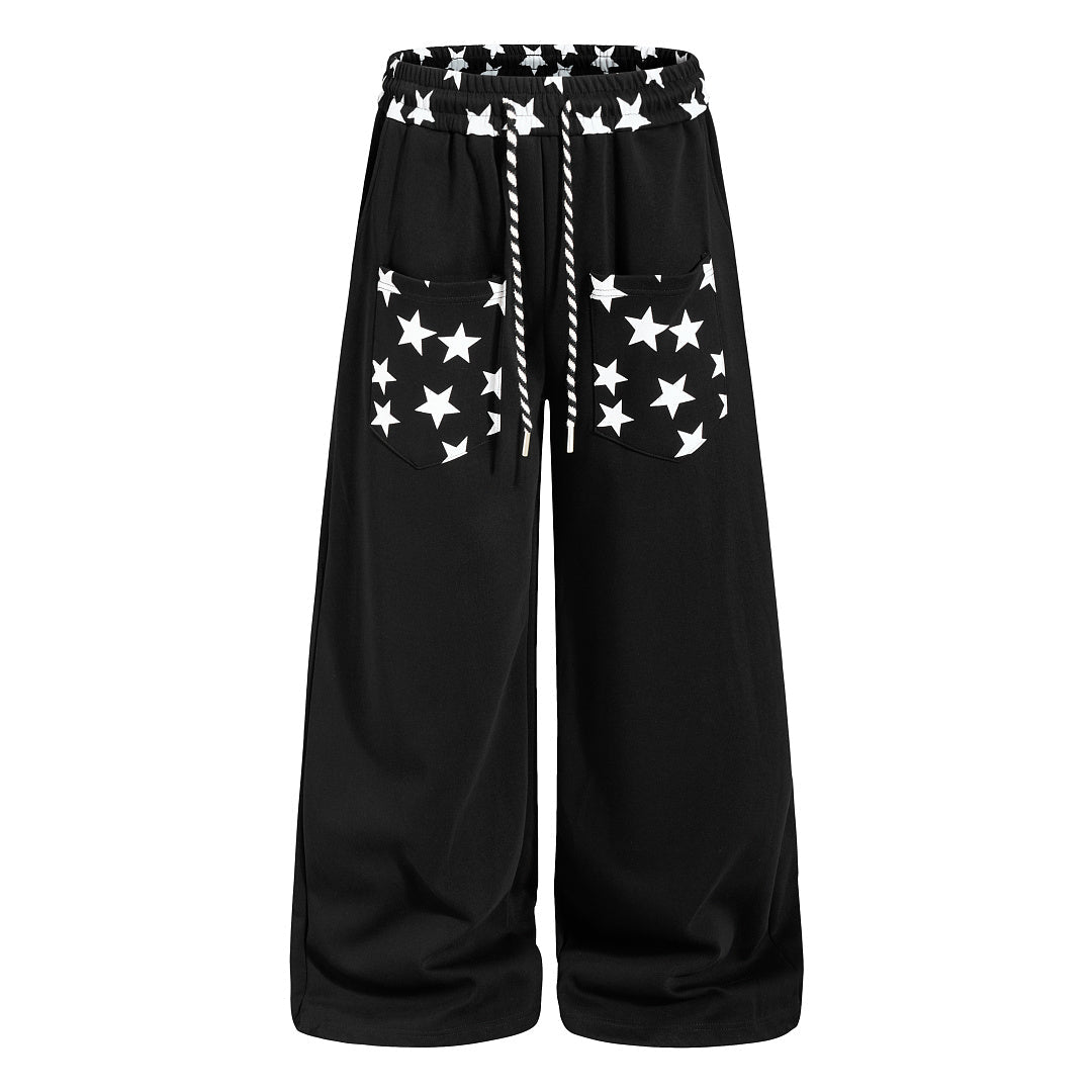 Front view of star print baggy sweatpants with a loose fit