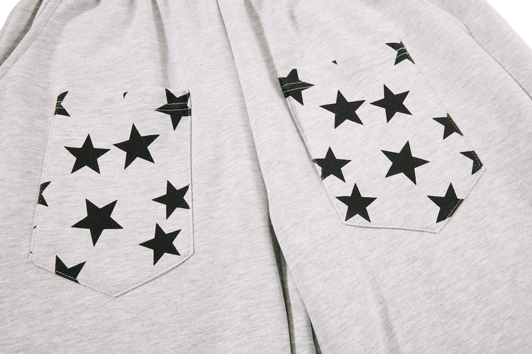 Side view of baggy star print sweatpants showing the relaxed cut
