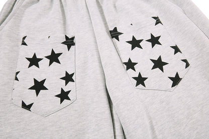 Side view of baggy star print sweatpants showing the relaxed cut