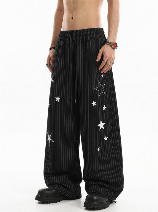 Star embroidered baggy barrel sweatpants shown in a relaxed silhouette