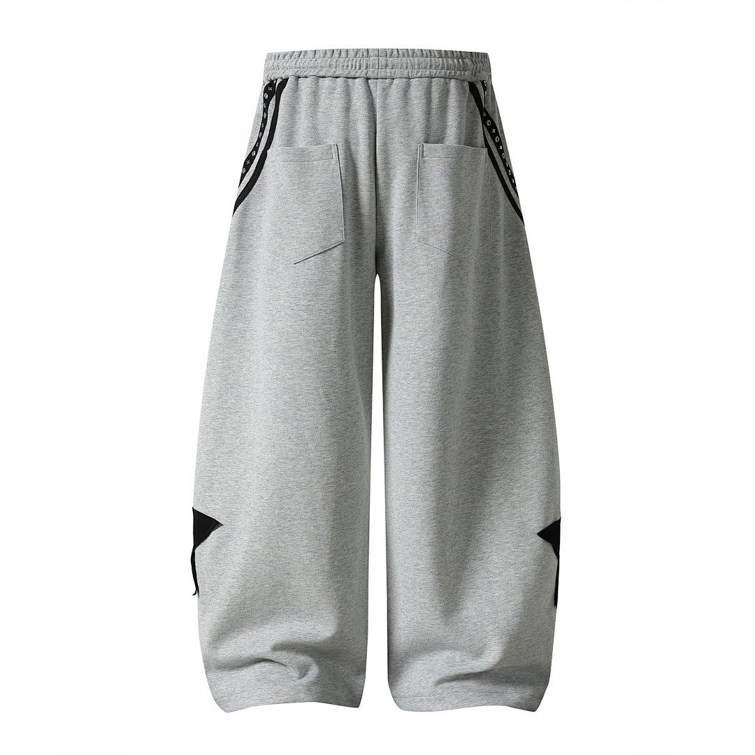 Detail view of the waistband and drawstring on the baggy sweatpants