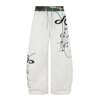 Side view of camouflage sweatpants with a loose barrel-leg shape