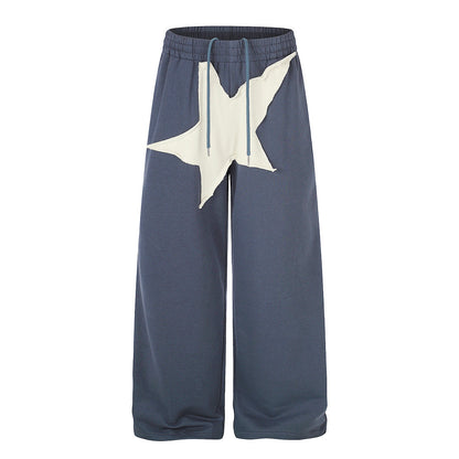Front view of oversized star appliqué wide leg joggers