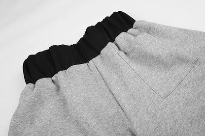 Waist and leg detail of layered waist star panel sweatpants