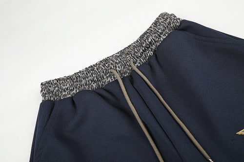 Close-up of the leopard star print on soft sweatpants fabric