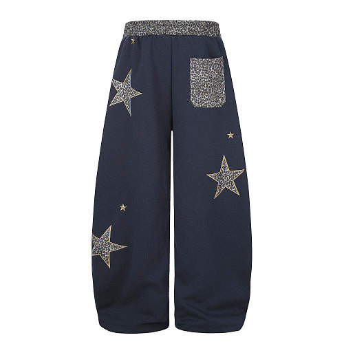 Casual baggy sweatpants styled with contemporary streetwear pieces