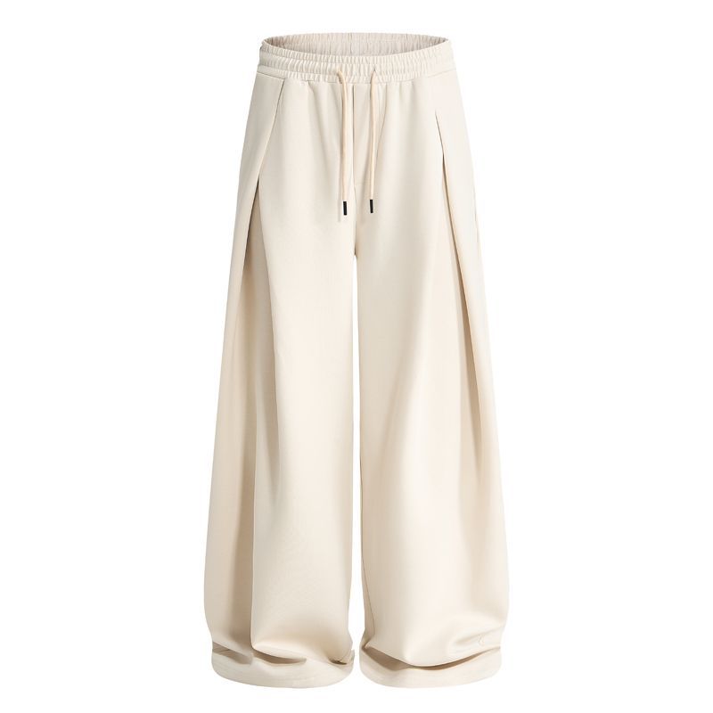 Side view of baggy sweatpants with pleat detailing and a comfortable fit