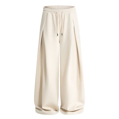 Side view of baggy sweatpants with pleat detailing and a comfortable fit