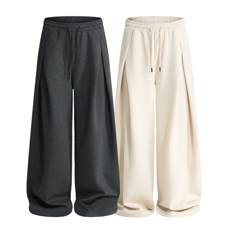 Back view of pleated sweatpants with a relaxed silhouette and elastic waist
