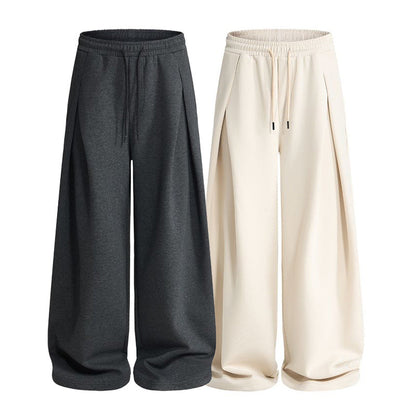 Back view of pleated sweatpants with a relaxed silhouette and elastic waist