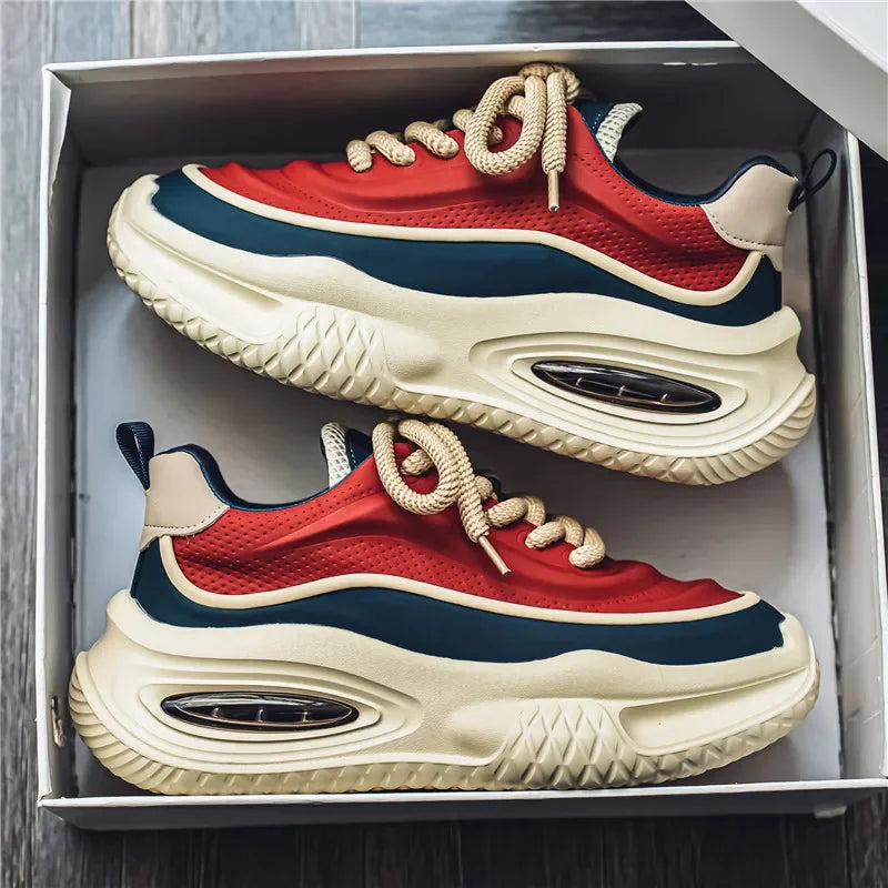 Chunky trainers with red, black and beige panels, angled view