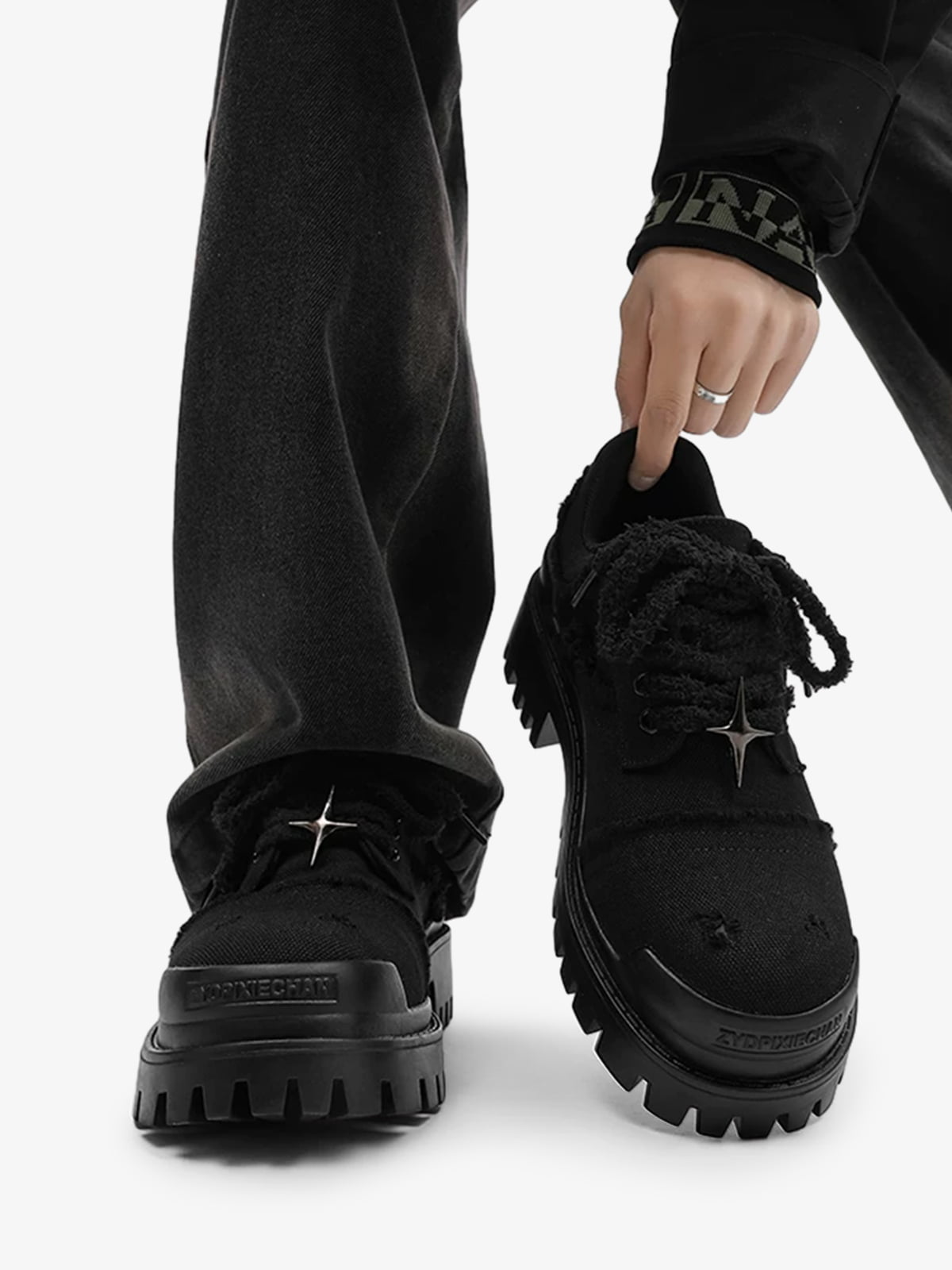 Side view of black chunky platform trainers with a raised platform sole