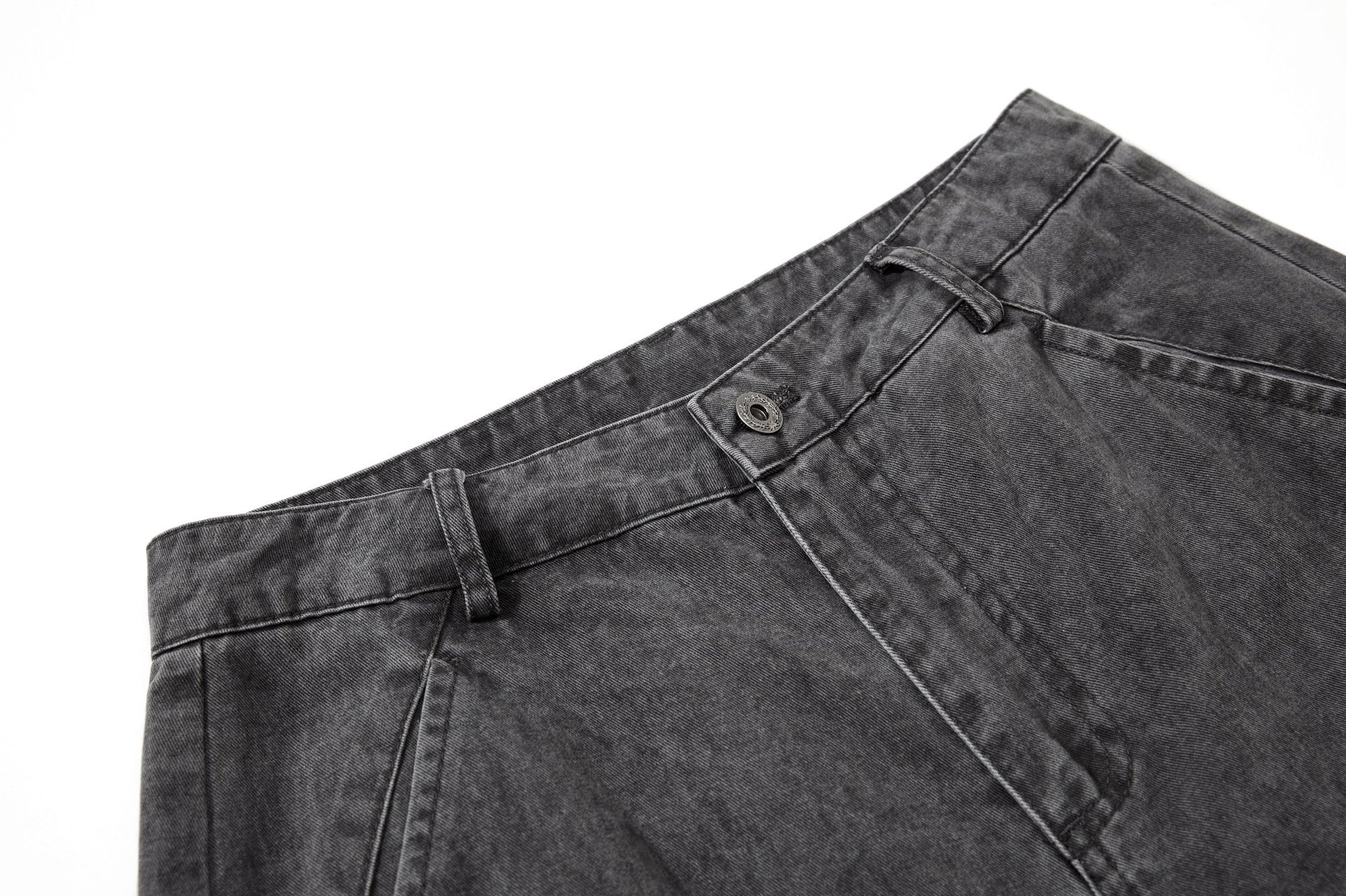 Close-up of cargo trouser fabric with a washed cotton finish