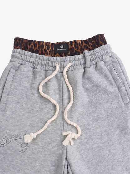 Leg opening detail of double waist jogger shorts in heathered fabric