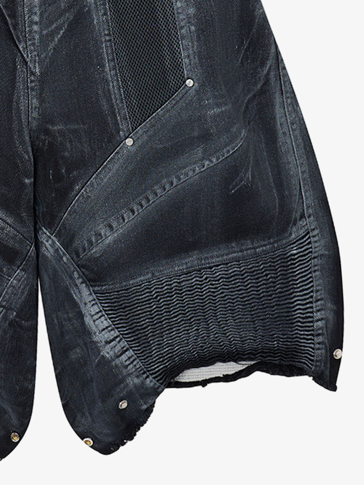 Studio image of layered denim shorts with mesh panels and double waist design