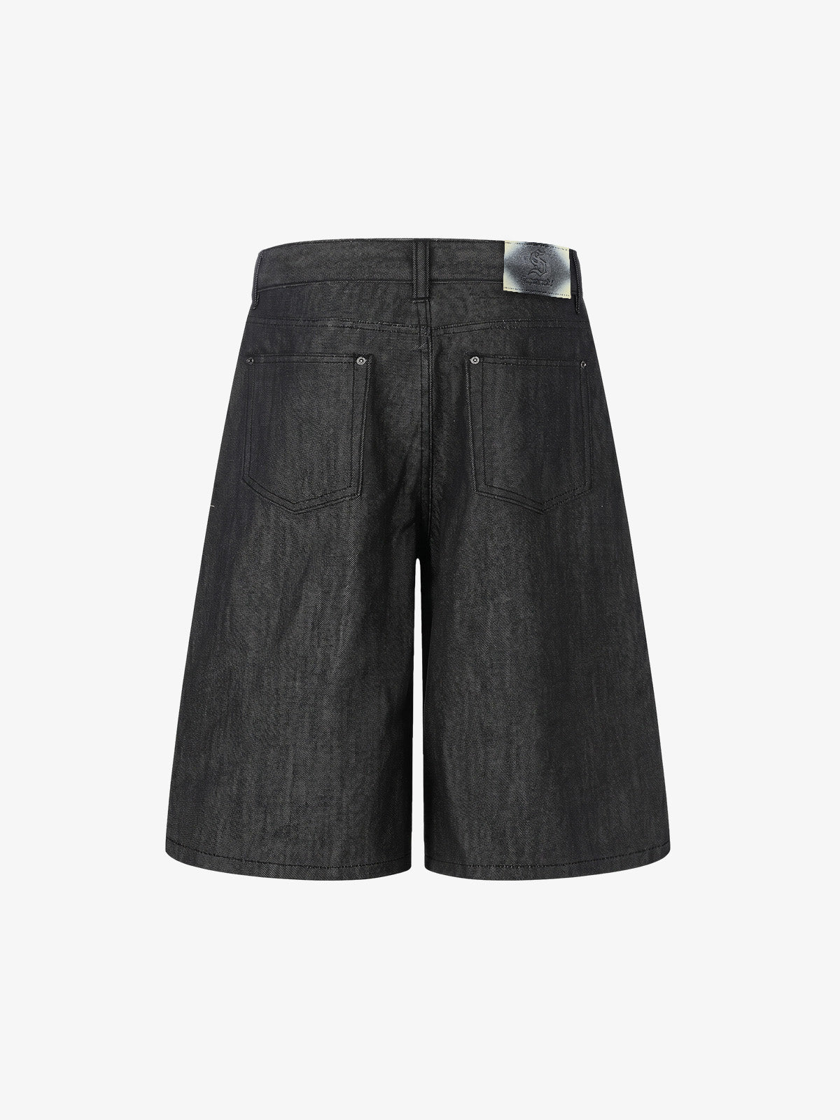 Rear view of black denim shorts with patchwork panels and stud accents