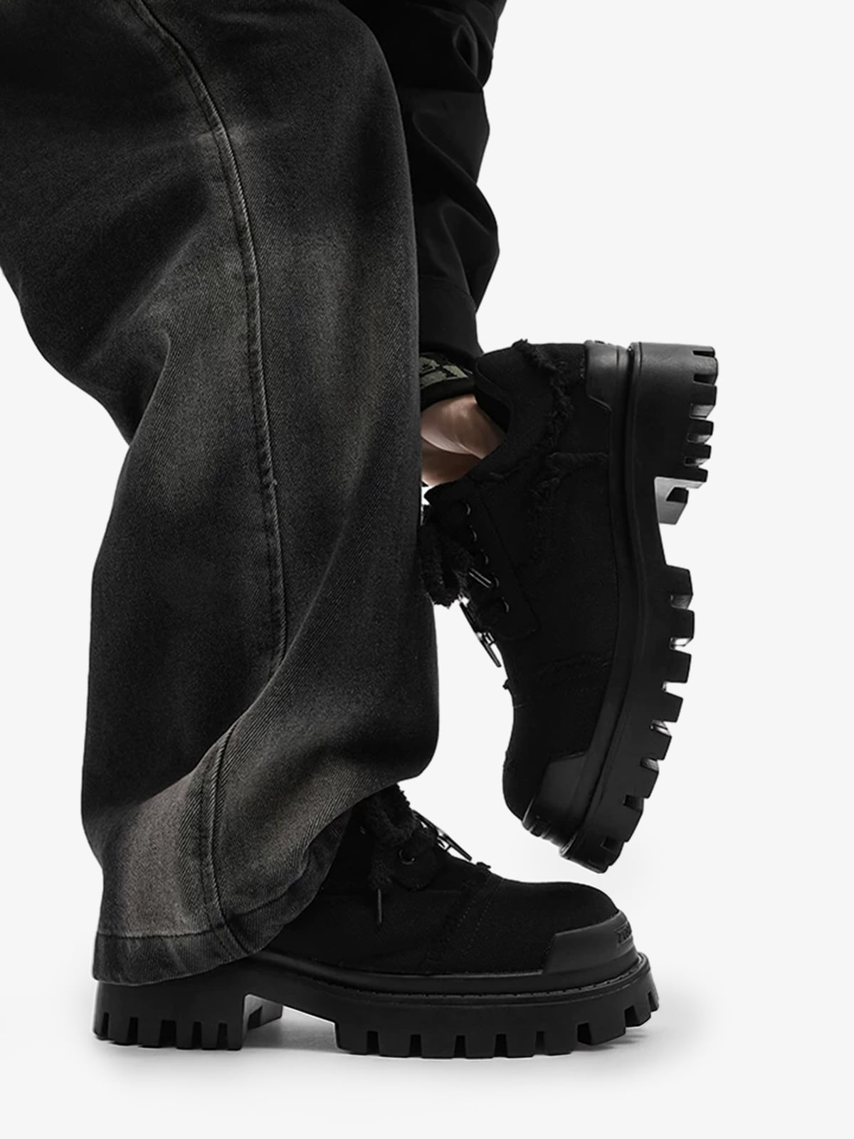 Pair of black chunky trainers showing the thick platform sole