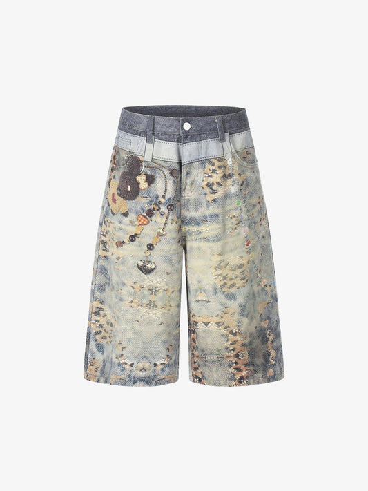 Front view of wide-leg denim culotte shorts with beaded chain detail