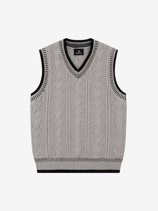 Men's cable knit V-neck jumper shown from the front in a classic retro-inspired style