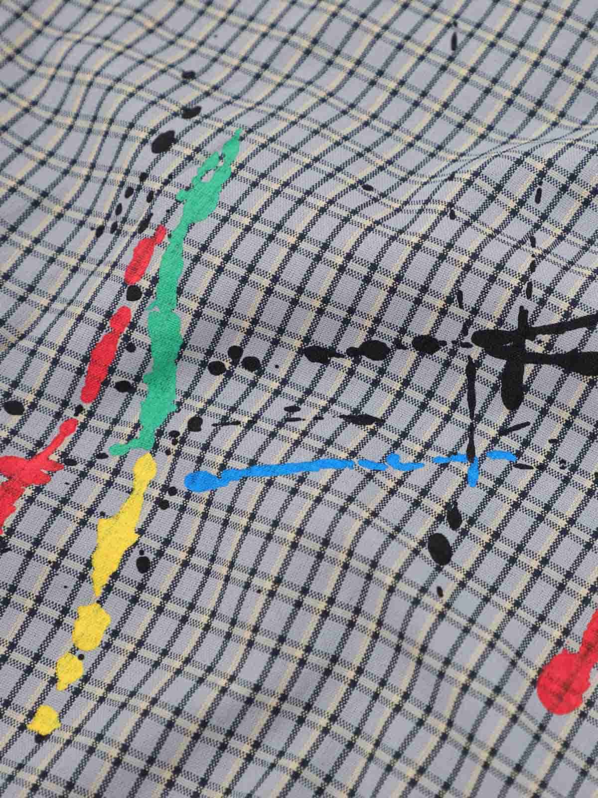 Long sleeve men's plaid shirt with embroidered detail on model