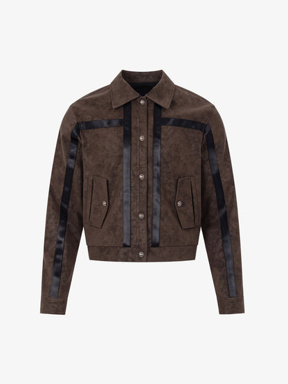 Front view of a brown faux leather cropped jacket with a distinctive patchwork design