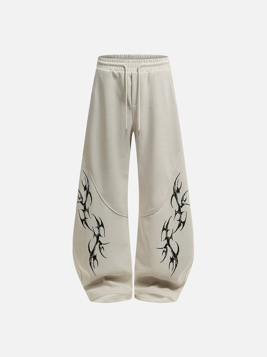 Front view of wide-leg graphic sweatpants with abstract tribal print