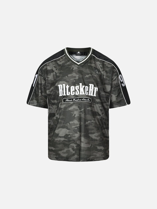 Front view of oversized camo jersey top with graphic front and V-neck