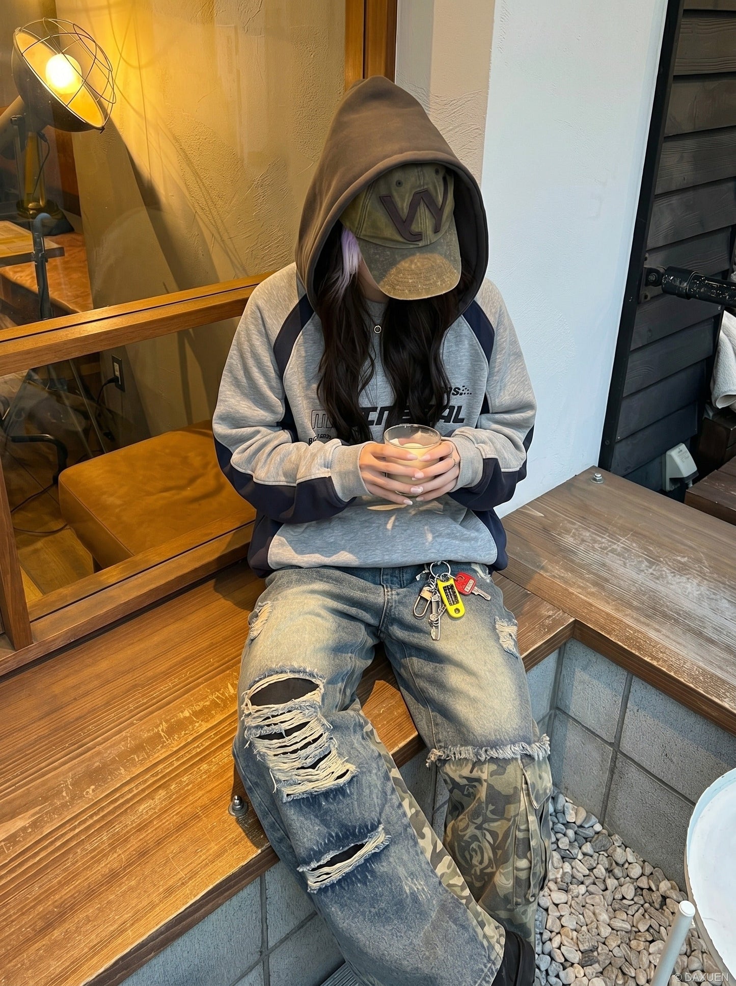 Waistband and front fastening on distressed camouflage jeans
