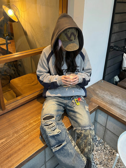 Waistband and front fastening on distressed camouflage jeans