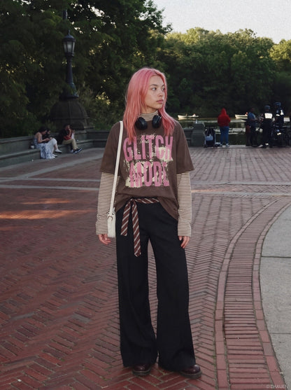 Hem and sleeve detail of oversized layered graphic T-shirt
