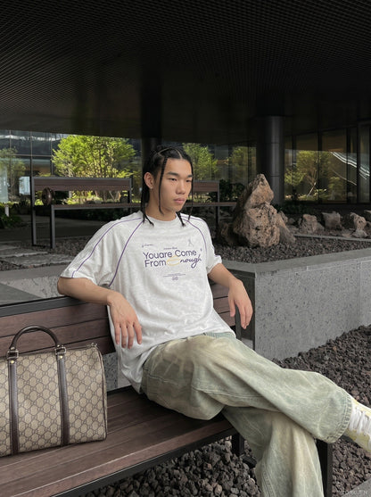 Close-up of crew neck on oversized graphic T-shirt